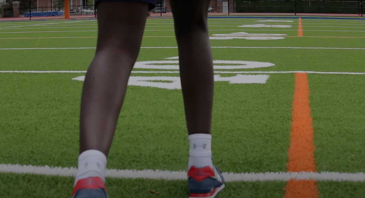 Athlete preparing to run on football field