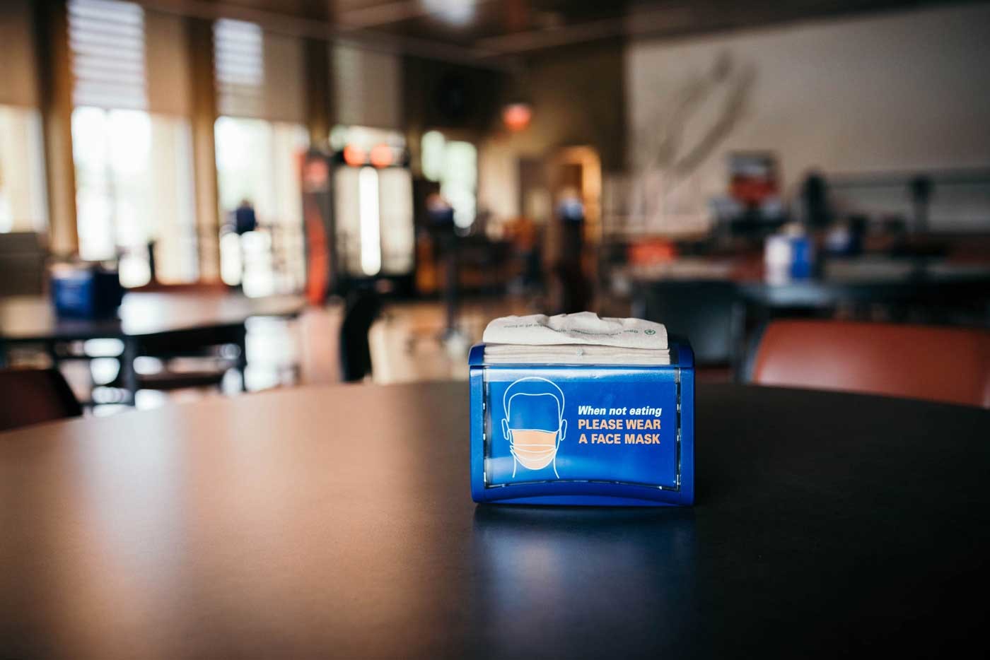 napkin holder in the Atrium reminds ‘When not eating, please wear a face mask’