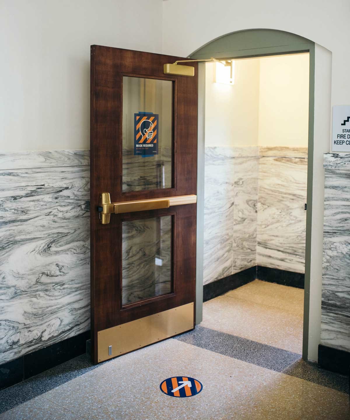 floor and doorway signage with diagonal orange/blue background theme