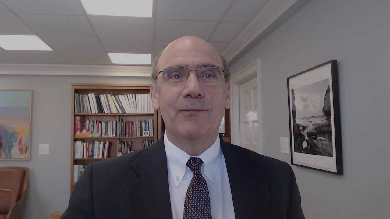 Bob Iuliano standing in his office wearing a suit