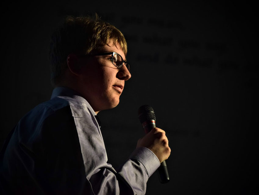 Carter Hanson speaking into a microphone