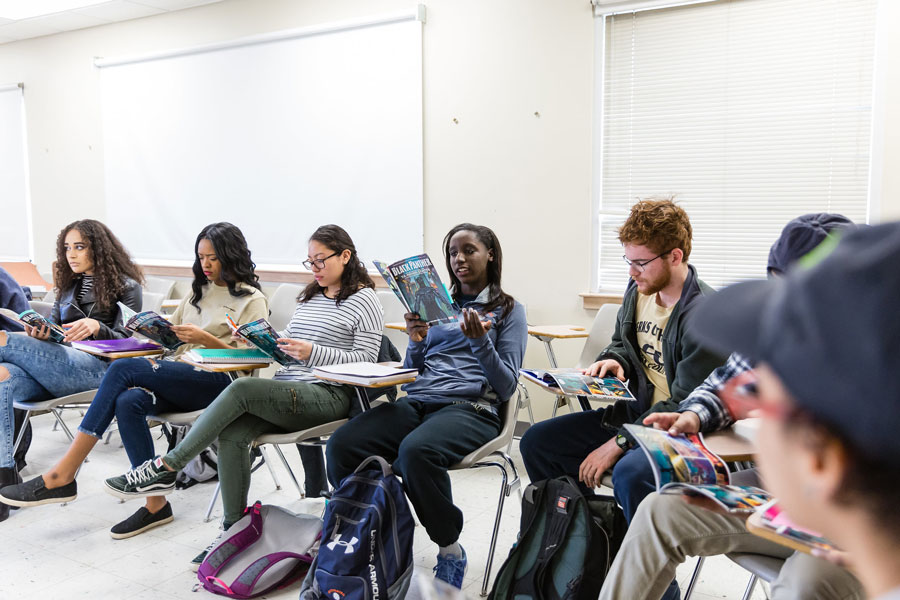 Students reading a comic book in a first year seminar