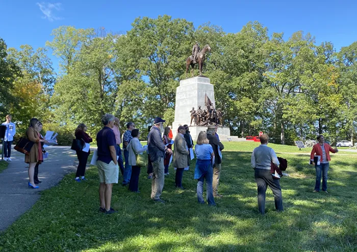 A group of people on an outdoor historical tour