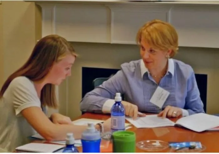 Two people seated at a table in discussion