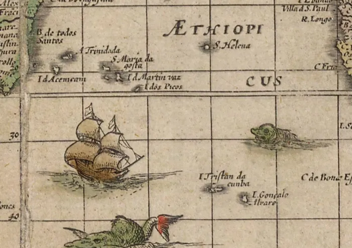 An antique map with ships and sea creatures.