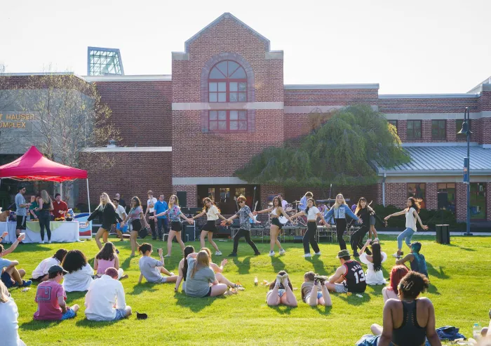 Students watch an event at Servo Field.