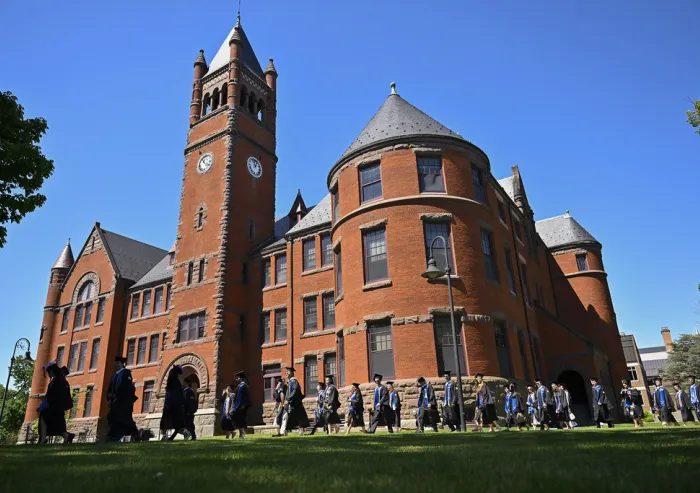 A group of graduates in front of the Glatfelter Hall