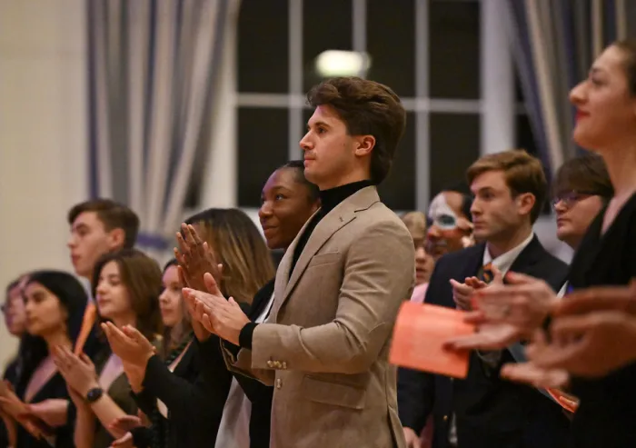 A group of people clapping their hands