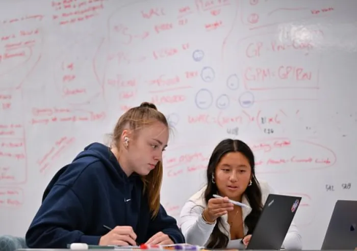 Two students collaborating in a classroom