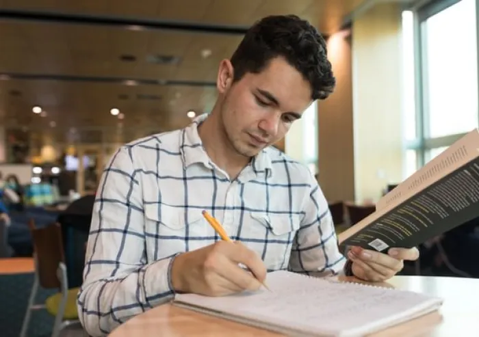 Student studying with a book