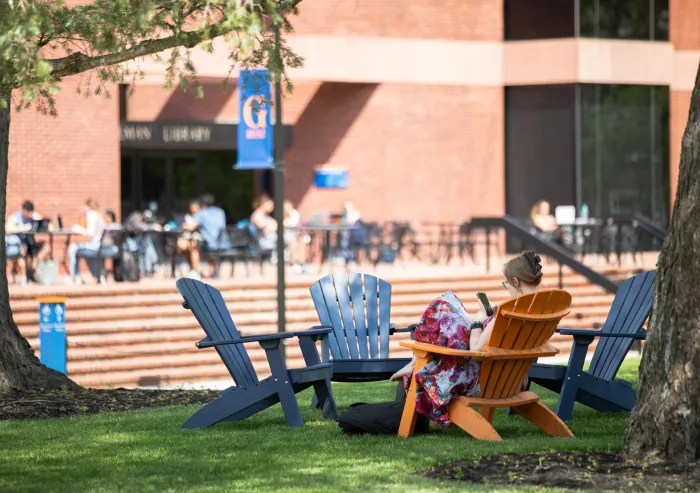 students sit outside library