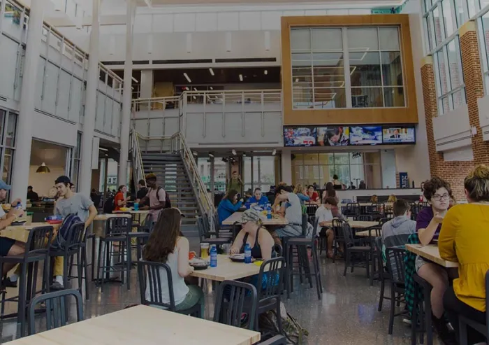 Students sit at the tables in the College Union Building.