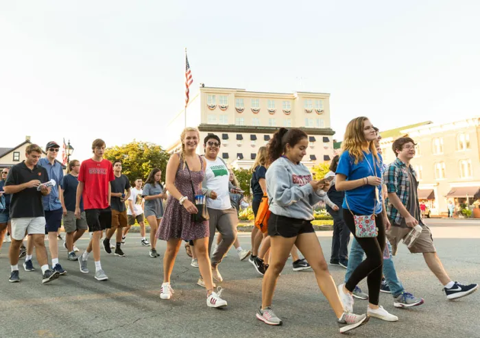 Students walk down the street during the first-year walk.