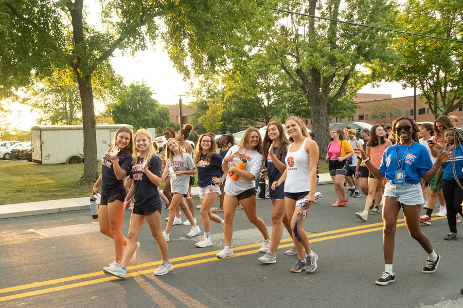 students walk through town together on First Year Walk