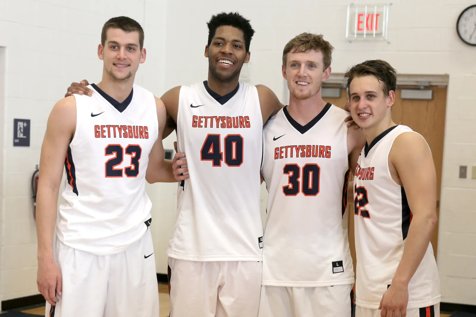 four mens basketball players