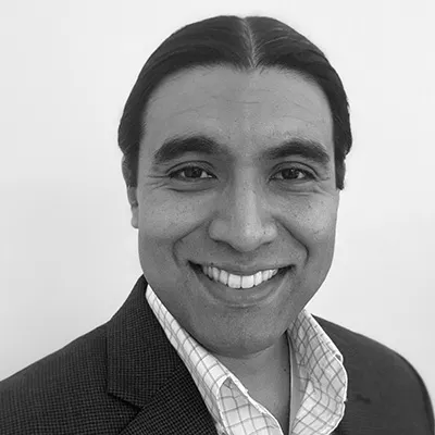 headshot of smiling man with dark hair
