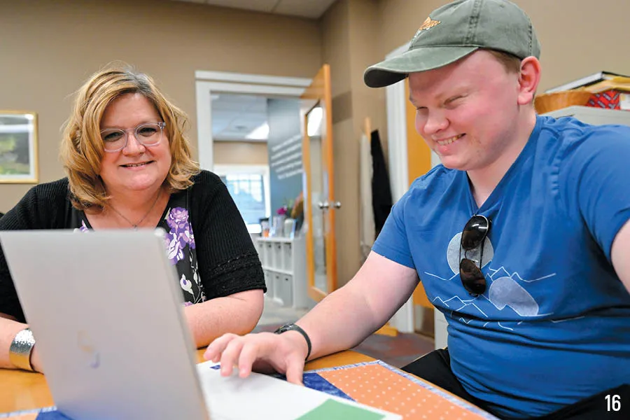 advisor meets with student with laptop