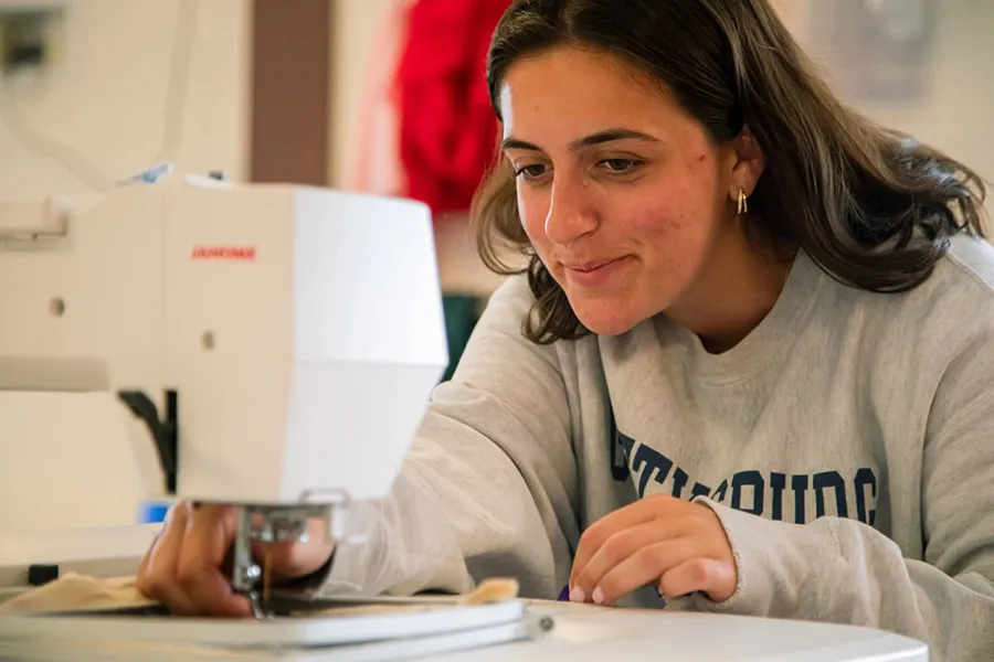 Emma Hladik ’24 works on an embroidered design in the lab