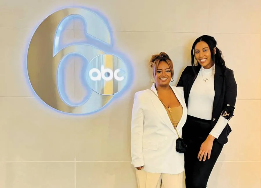 women smile together in front of ABC6 logo on wall
