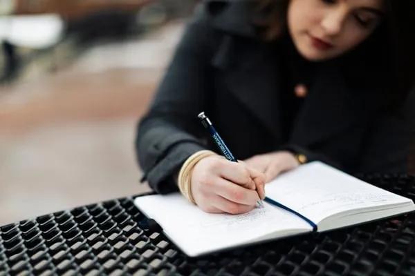 student writes in journal