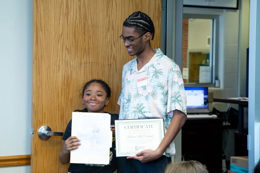 McFarland and Cymere with a Certificate of Appreciation.