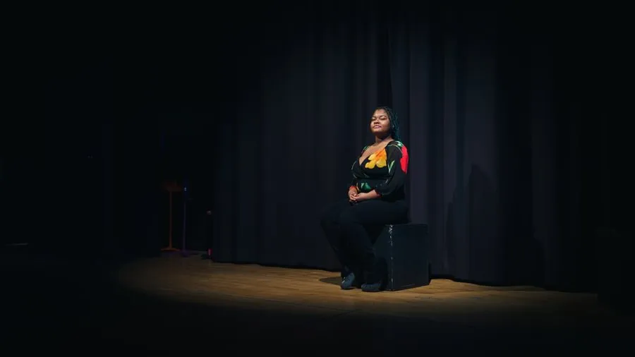 Britney Brunache ’22 is seen on stage at Gettysburg College’s Stevens Theatre.