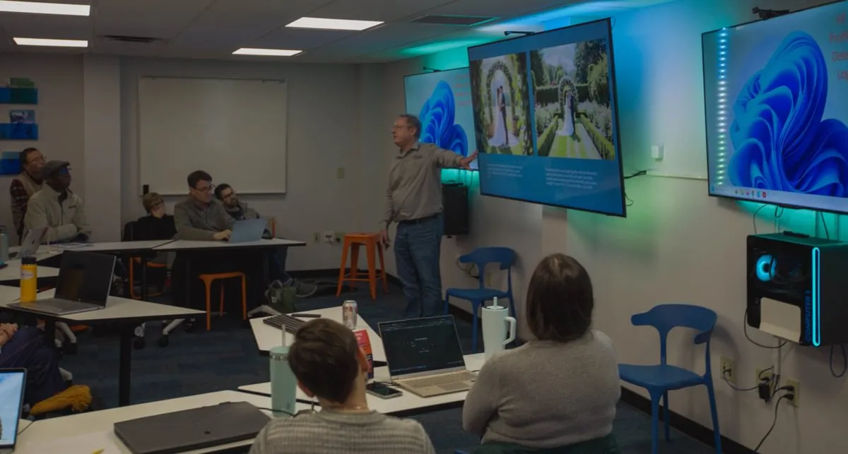 presenter at front of room gestures toward images on screen