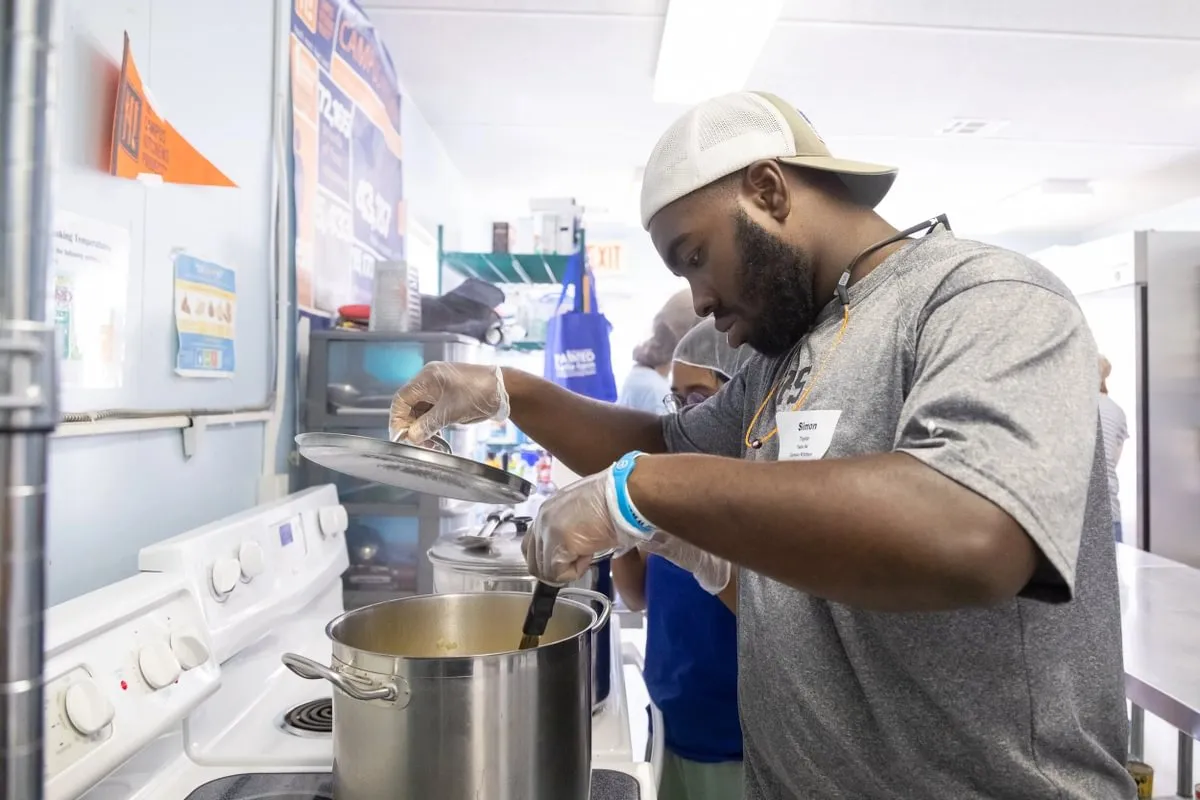 students cook together in kitchen