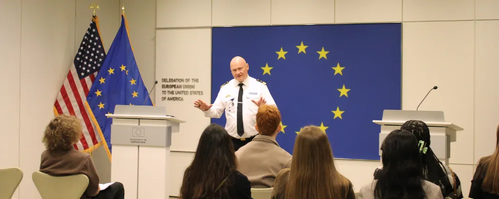 A military officer in uniform gestures while speaking to a group of Gettysburg College students in a conference room