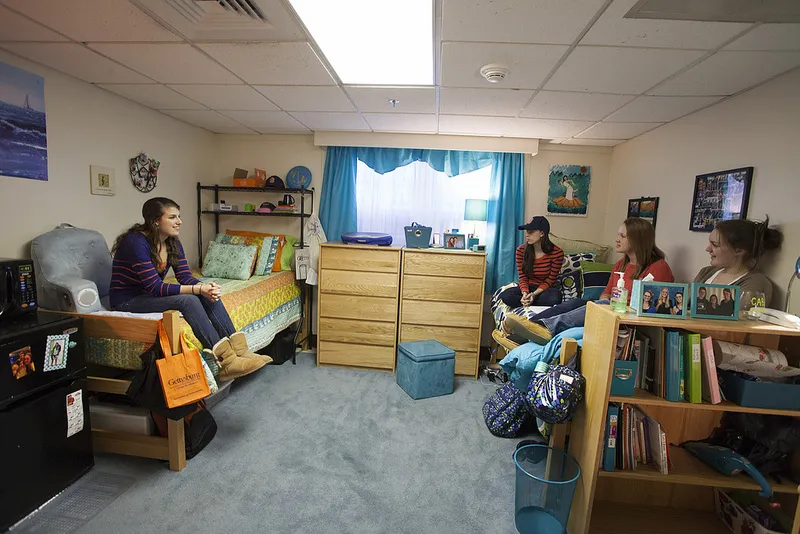Students sit in a residence hall dorm room