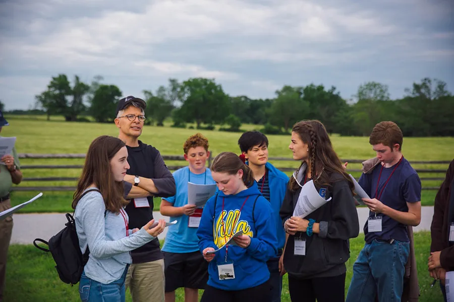 Historians gathered during an outdoor battlefield tour
