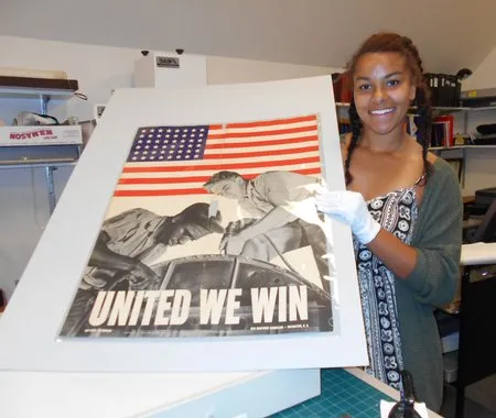 Lauren Bradford holds a poster in a workshop.