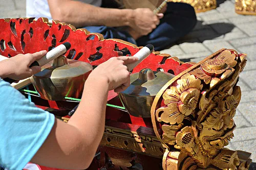 Balinese gamelan player with a decorated metallophone.