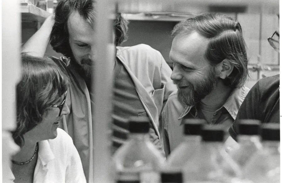 Michael Bishop ’57, 1989 Nobel Prize winner talking with friends.