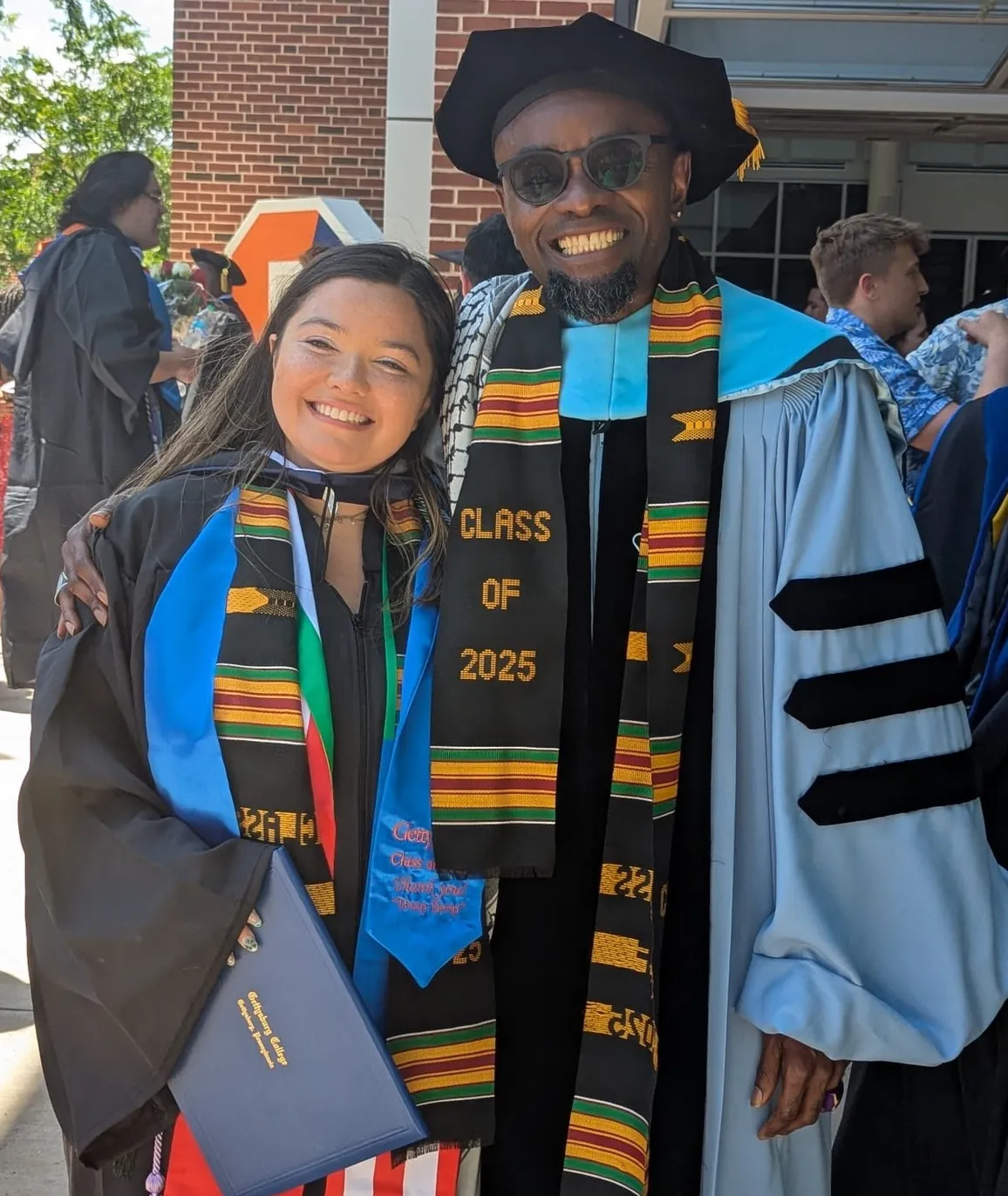 student and prof at Commencement in regalia