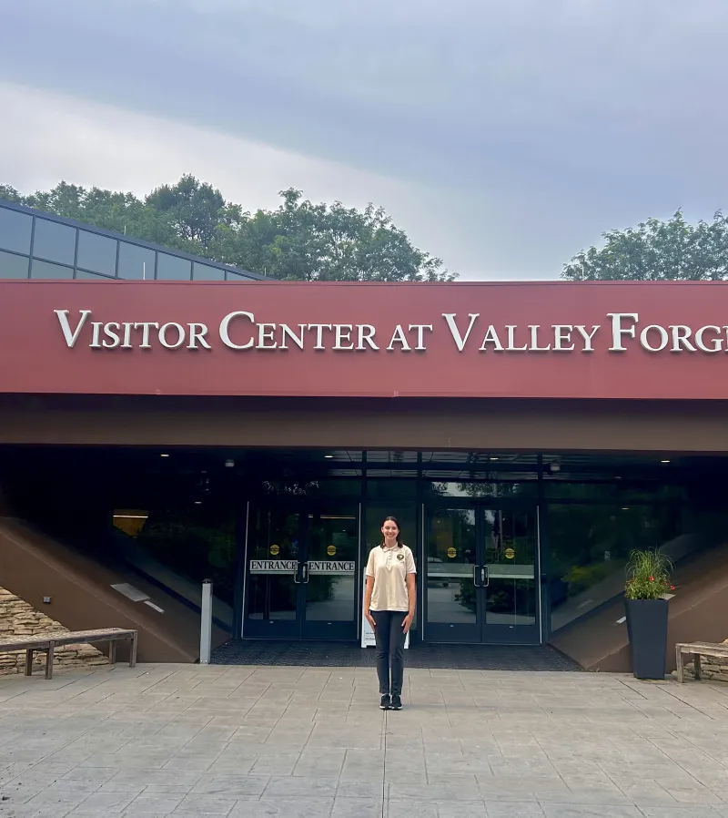 Ella Koup stands in front of entrance to Valley Forge National Park visitor center