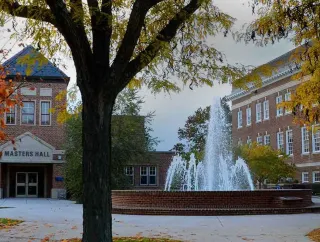 Gettysburg College’s Masters Hall and fountain framed by colorful autumn trees.