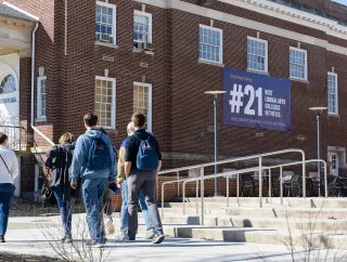 students walking by banner