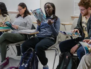 A group of students sit in a classroom.