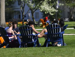 A group of students sit on campus.