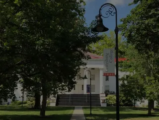 An image of the Pennsylvania Hall behind the trees