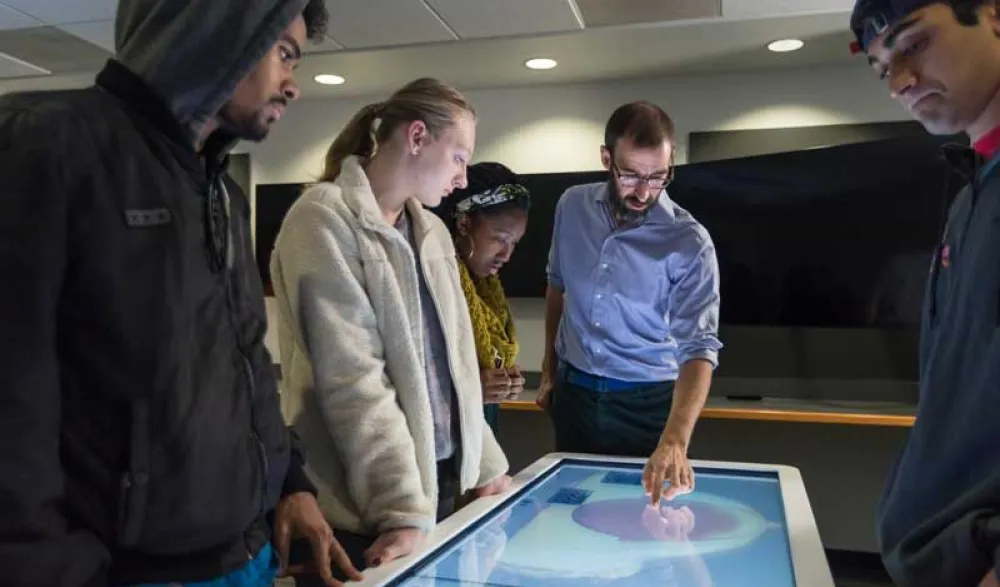students and prof at anatomage table