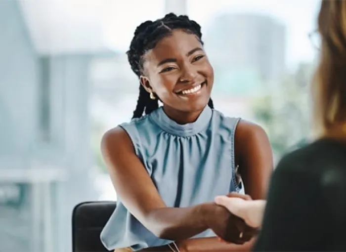 female student shakes employer's hand