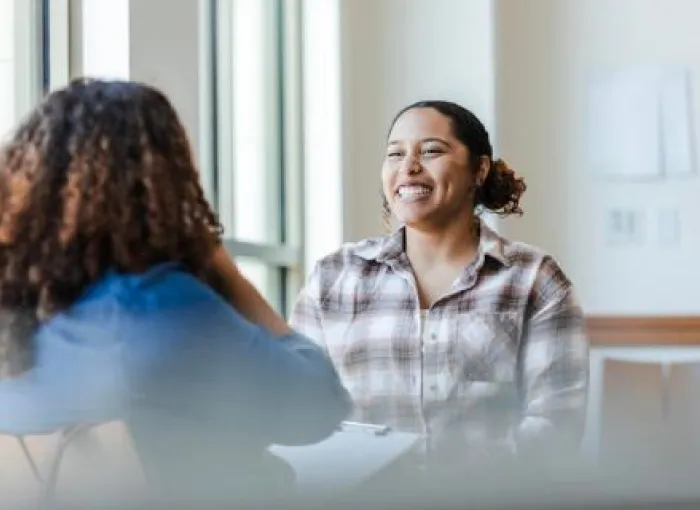 An image of two female students chatting