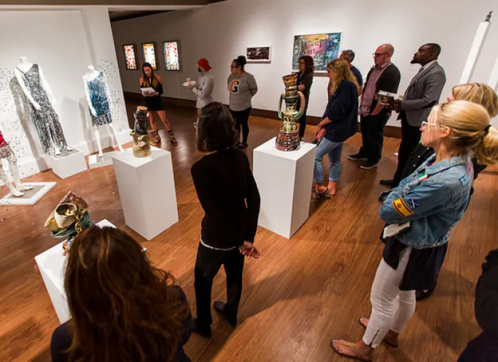 A group of people attend an art exhibit.