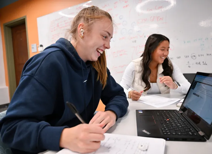 students laughing together as they study