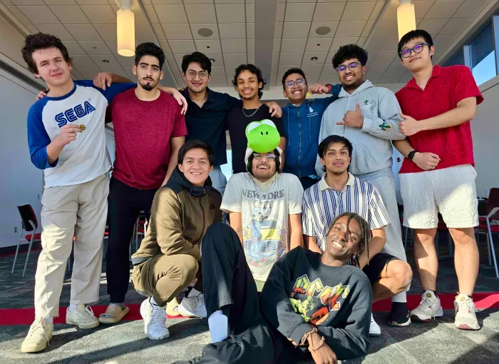 group of students pose together, smiling for camera