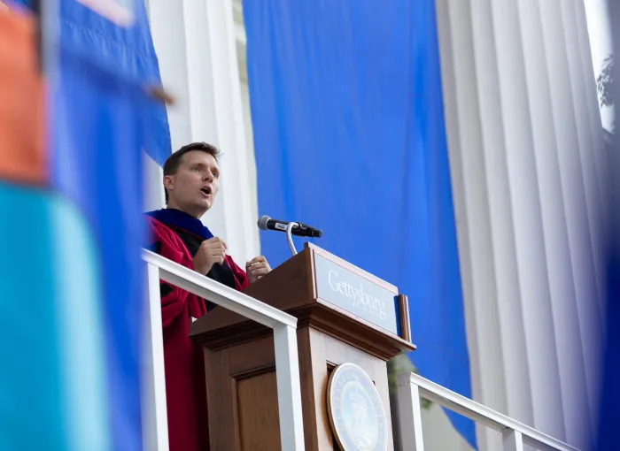 Prof speaks from podium at Convocation