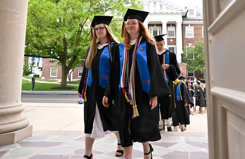 A group of graduates walking in to hall