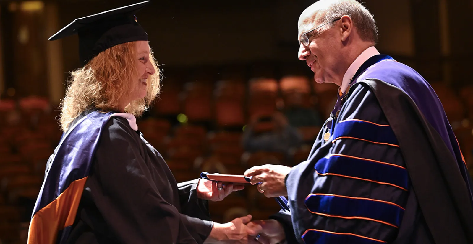Gettysburg College President Bob Iuliano presents a Stole of Gratitude to a graduate 